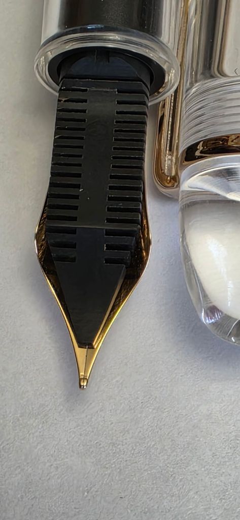 Ebonite feed. Fine nib, writes smoothly straight out of the box. 